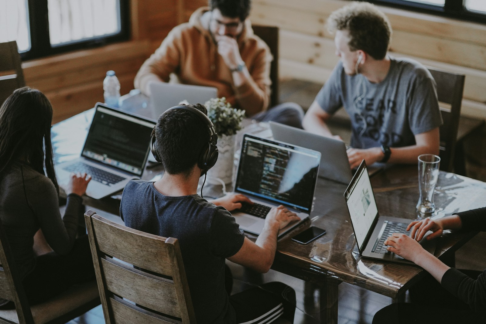 Team of developers working together around a wooden table