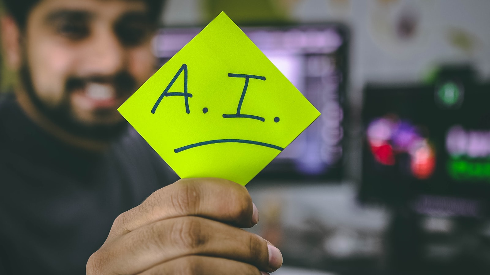 Developer holding a sticky note that reads A.I.