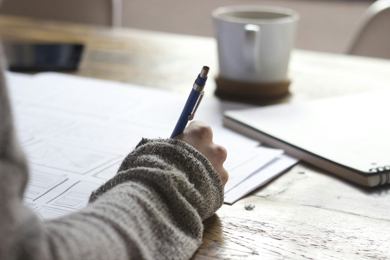 Hand writing notes with a pen on paper