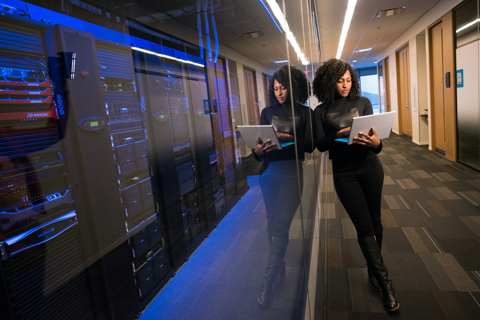 Engineer with a laptop standing in a server room
